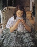 The girl is sewing in green dress